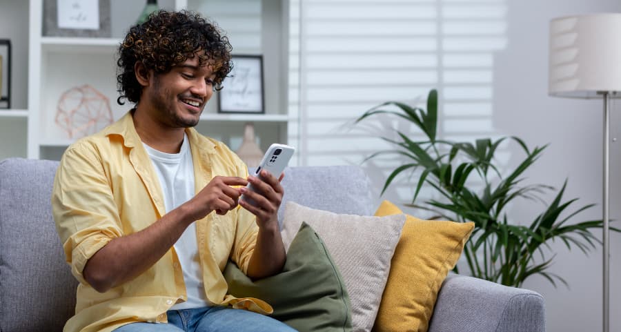 Man accessing a home security app on his smartphone